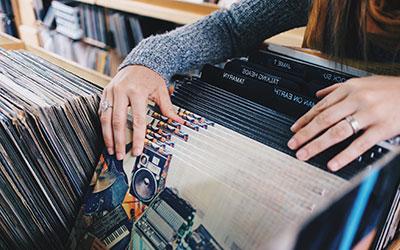 Woman flipping through Vinyl Records.